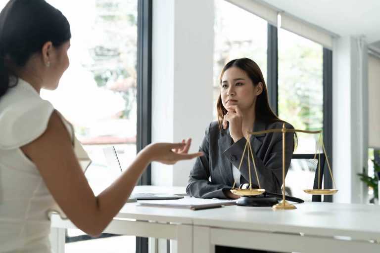 asian female lawyer discussing negotiation legal case with client meeting with document contact in