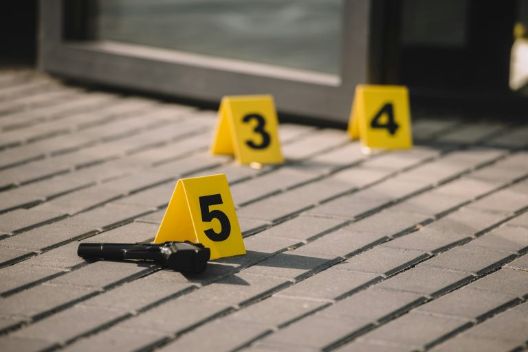 close up view of crime scene with gun and numbers