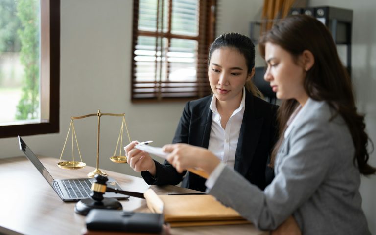 Female Lawyer Litigation Trial Lawyer office. Statue of Justice with scales and lawyer working on a