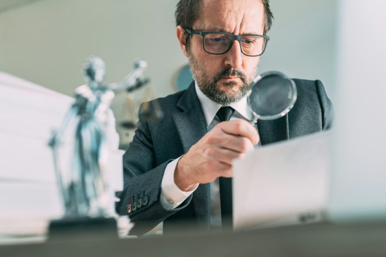 Lawyer reading legal contract agreement in law practice office