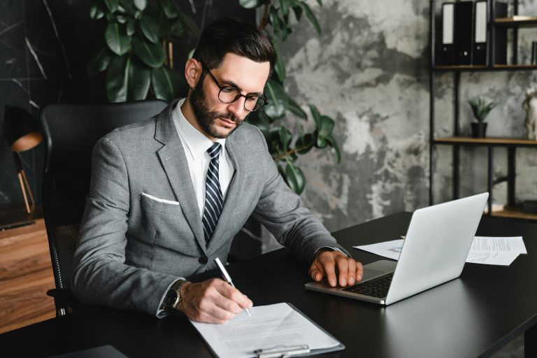 Managerial work performed by young businessman in modern office.