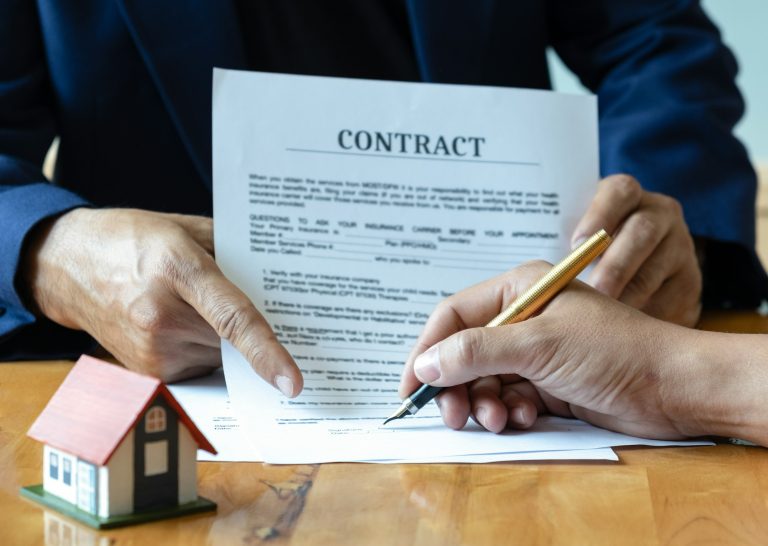 Signing a home purchase contract.