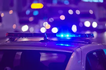 Police patrol car at night, symbolizing enforcement challenges addressed by Civil Rights Law in Philadelphia